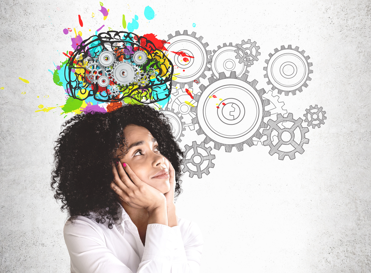 The image shows a smiling young African American woman in front of a brain and gear graphic. It represents how as we understand more about the brain there has been a destigmatization of mental health care and a rise in ADHD diagnoses.